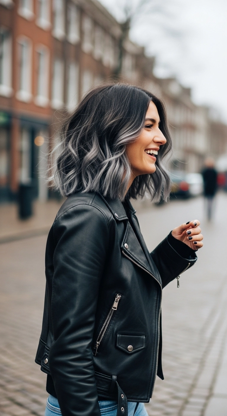 Woman with a wavy lob haircut colored with a metallic gunmetal gray balayage